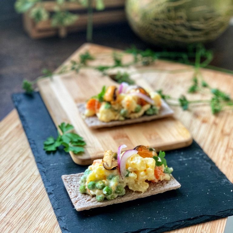Homemade russian salad with pickled mussels